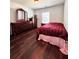 Bedroom with dark hard wood flooring, single window and dark furniture at 779 Harvest Brook Dr, Lawrenceville, GA 30043