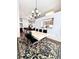 Dining space with statement rug, pendant lighting, and a view through to the Gathering room at 779 Harvest Brook Dr, Lawrenceville, GA 30043
