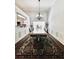 Long dining room with trim, large table and a chandelier at 779 Harvest Brook Dr, Lawrenceville, GA 30043