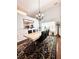 Well-lit dining area features a decorative rug, pendant lighting, and a view into the kitchen at 779 Harvest Brook Dr, Lawrenceville, GA 30043
