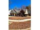Well-maintained house with lush landscaping, a driveway, and a charming curb appeal at 779 Harvest Brook Dr, Lawrenceville, GA 30043