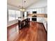 Kitchen boasts an island with seating, white cabinetry, stainless steel appliances, and hardwood flooring at 779 Harvest Brook Dr, Lawrenceville, GA 30043