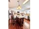 Kitchen with island and barstool seating, white cabinets, stainless steel appliances, and hardwood floors at 779 Harvest Brook Dr, Lawrenceville, GA 30043