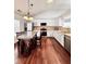 Kitchen features an island with barstool seating, white cabinets, stainless appliances, and hardwood floors at 779 Harvest Brook Dr, Lawrenceville, GA 30043