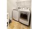 Modern laundry room featuring front loading washer and dryer on tile flooring at 779 Harvest Brook Dr, Lawrenceville, GA 30043