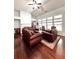 Spacious living area with hardwood floors, a fireplace, and comfortable seating at 779 Harvest Brook Dr, Lawrenceville, GA 30043