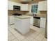 Kitchen features stainless steel appliances, tile floors, granite countertops, a center island, and ample cabinet space at , Stone Mountain, GA 30087