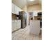 This kitchen features stainless steel appliances, white cabinetry, tile floors, and granite countertops at , Stone Mountain, GA 30087