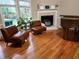 Cozy living room features a fireplace, hardwood floors, and natural light from the surrounding windows at , Stone Mountain, GA 30087