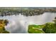 Panoramic aerial view showcases a lake and golf course surrounded by beautiful homes at 1100 Muirfield Ct, Alpharetta, GA 30005