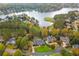 Stunning aerial view of a beautiful home nestled among trees with lake and golf course views at 1100 Muirfield Ct, Alpharetta, GA 30005