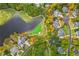 Picturesque aerial view of homes alongside a golf course and serene lake at 1100 Muirfield Ct, Alpharetta, GA 30005
