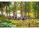Secluded backyard patio with stone fireplace, perfect for relaxing and entertaining outdoors with lake view at 1100 Muirfield Ct, Alpharetta, GA 30005