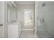 Bright bathroom featuring a white vanity, large mirror, and glass-enclosed shower at 1100 Muirfield Ct, Alpharetta, GA 30005