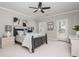 Inviting bedroom with neutral decor, a dark wood bed frame, and soft lighting at 1100 Muirfield Ct, Alpharetta, GA 30005
