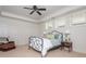 Cozy bedroom features an iron bed frame, white trim, a ceiling fan, and three windows offering ample natural light at 1100 Muirfield Ct, Alpharetta, GA 30005