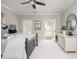 Serene bedroom with neutral tones, outdoor access, and a decorative dresser at 1100 Muirfield Ct, Alpharetta, GA 30005