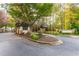 Community entrance to a gated neighborhood with stone pillars and landscaping at 1100 Muirfield Ct, Alpharetta, GA 30005