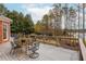 An expansive wooden deck with outdoor furniture offers a scenic view, perfect for relaxation and entertaining at 1100 Muirfield Ct, Alpharetta, GA 30005
