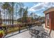 An inviting outdoor deck provides lake views, and features a patio set perfect for entertaining and relaxation at 1100 Muirfield Ct, Alpharetta, GA 30005