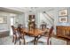 Dining room leading into staircase and foyer with hardwood flooring and decor at 1100 Muirfield Ct, Alpharetta, GA 30005