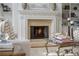 Close up view of the white mantle fireplace with decorative decor and ornate details at 1100 Muirfield Ct, Alpharetta, GA 30005