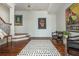 Grand foyer with hardwood floors, elegant rug, and stylish decor at 1100 Muirfield Ct, Alpharetta, GA 30005