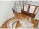 Grand foyer featuring a curved staircase, hardwood floors, and a decorative chandelier at 1100 Muirfield Ct, Alpharetta, GA 30005