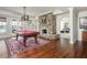 Spacious game room featuring a pool table, stone fireplace, and ample natural light at 1100 Muirfield Ct, Alpharetta, GA 30005