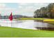 Golf course view with a putting green and lake, creating an idyllic setting for golf enthusiasts at 1100 Muirfield Ct, Alpharetta, GA 30005