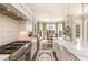 Gourmet kitchen featuring a large island, chef's stove, farmhouse sink, and lots of windows at 1100 Muirfield Ct, Alpharetta, GA 30005
