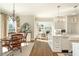 Bright and airy kitchen with a breakfast nook and a view to the living room fireplace at 1100 Muirfield Ct, Alpharetta, GA 30005