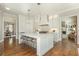 Open-concept kitchen with a large island, stainless appliances, and adjacent dining area at 1100 Muirfield Ct, Alpharetta, GA 30005