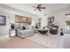 Bright and airy living room with neutral decor, large windows, and comfortable seating at 1100 Muirfield Ct, Alpharetta, GA 30005