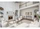 Bright, stylish living room with a fireplace, built-ins, and large windows at 1100 Muirfield Ct, Alpharetta, GA 30005