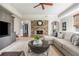 Cozy living room with stone fireplace, plush seating, and stylish built-in cabinetry at 1100 Muirfield Ct, Alpharetta, GA 30005