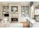 Living room with fireplace and built-ins, adjacent to a comfortable desk space at 1100 Muirfield Ct, Alpharetta, GA 30005