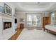 Main bedroom with fireplace and sitting area offering a relaxing retreat with natural light from the windows at 1100 Muirfield Ct, Alpharetta, GA 30005