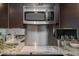 Detailed view of the kitchen showcasing stainless steel microwave, white stove top, and granite counters at 1101 Juniper Ne St # 612, Atlanta, GA 30309
