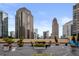 Rooftop deck featuring outdoor seating amidst a cityscape view and beautiful flower arrangements at 1101 Juniper Ne St # 612, Atlanta, GA 30309