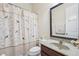 Charming bathroom with a shower, decorative curtain, and a granite-topped sink at 2220 Stirling Bridge Rd, Cumming, GA 30041