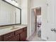 Bright bathroom with a granite countertop, dark wood cabinets, and views to the bedroom at 2220 Stirling Bridge Rd, Cumming, GA 30041
