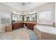 Spacious bathroom with double sinks, soaking tub, and large mirrors, perfect for relaxation at 2220 Stirling Bridge Rd, Cumming, GA 30041