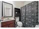 Stylish bathroom featuring a granite countertop, dark wood vanity, and tiled floors at 2220 Stirling Bridge Rd, Cumming, GA 30041