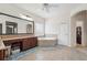 Bathroom featuring a corner tub, tile flooring, vanity, and a separate area for clothes at 2220 Stirling Bridge Rd, Cumming, GA 30041