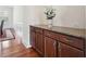 Hallway bar area with granite countertop, wine rack, and wood cabinets at 2220 Stirling Bridge Rd, Cumming, GA 30041