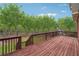 View of the expansive wooden deck with railing overlooking the backyard at 2220 Stirling Bridge Rd, Cumming, GA 30041