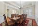 Spacious dining room with hardwood floors, decorative chandelier, and large windows at 2220 Stirling Bridge Rd, Cumming, GA 30041