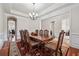 Dining room featuring a wooden table, elegant chairs, and decorative chandelier at 2220 Stirling Bridge Rd, Cumming, GA 30041