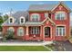 Beautiful two-story brick home with landscaped front yard and charming architectural details at 2220 Stirling Bridge Rd, Cumming, GA 30041